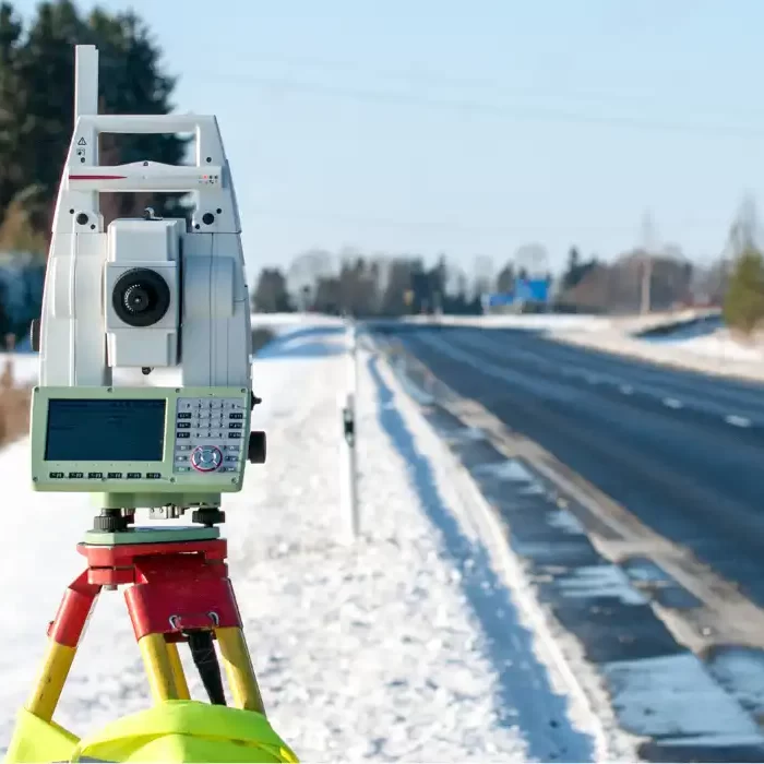 commercial-land-surveyor-ontario-1 Using a commercial land survey tripod during snow.