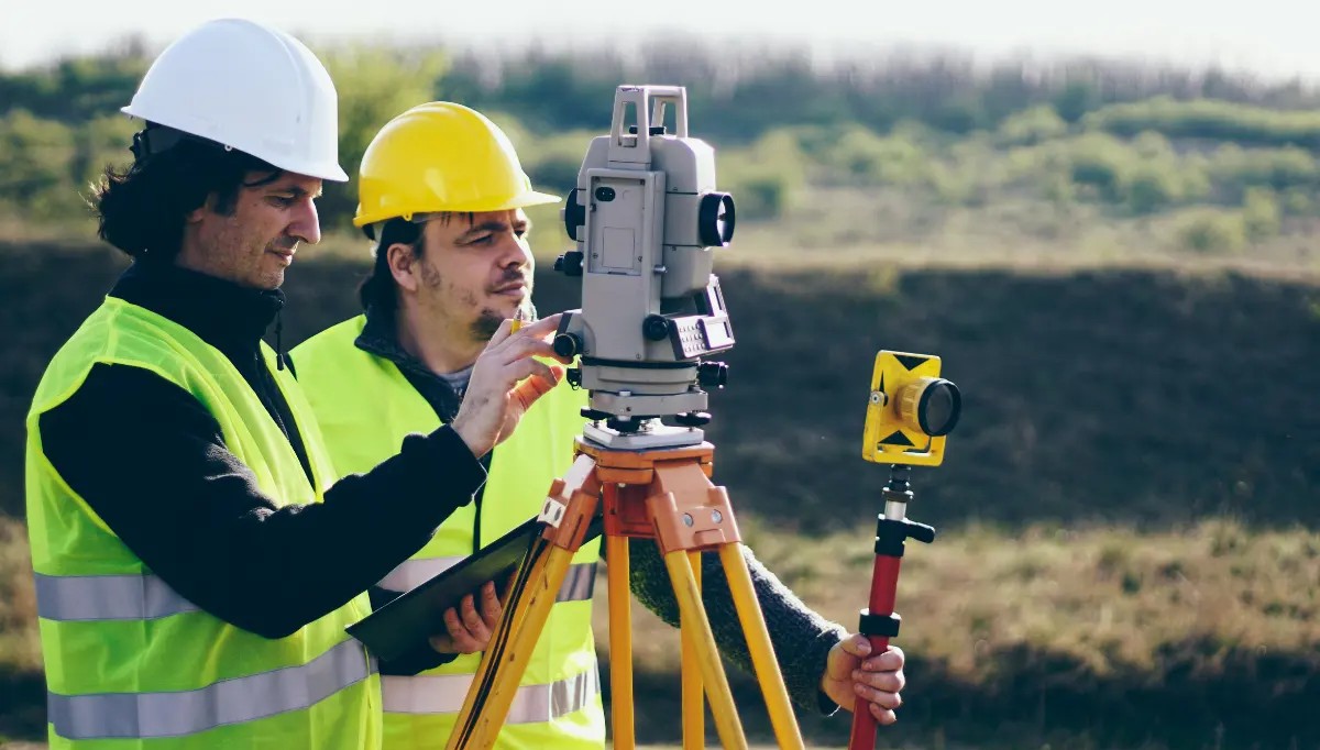 custom-home-project-survey-1 Two land surveyors.